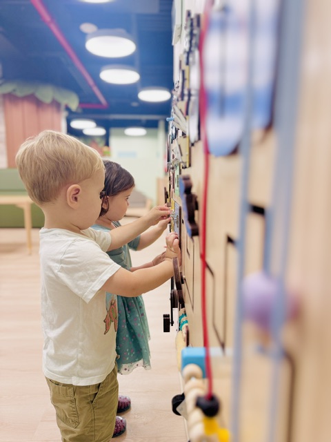 Children working together on educational wall activities